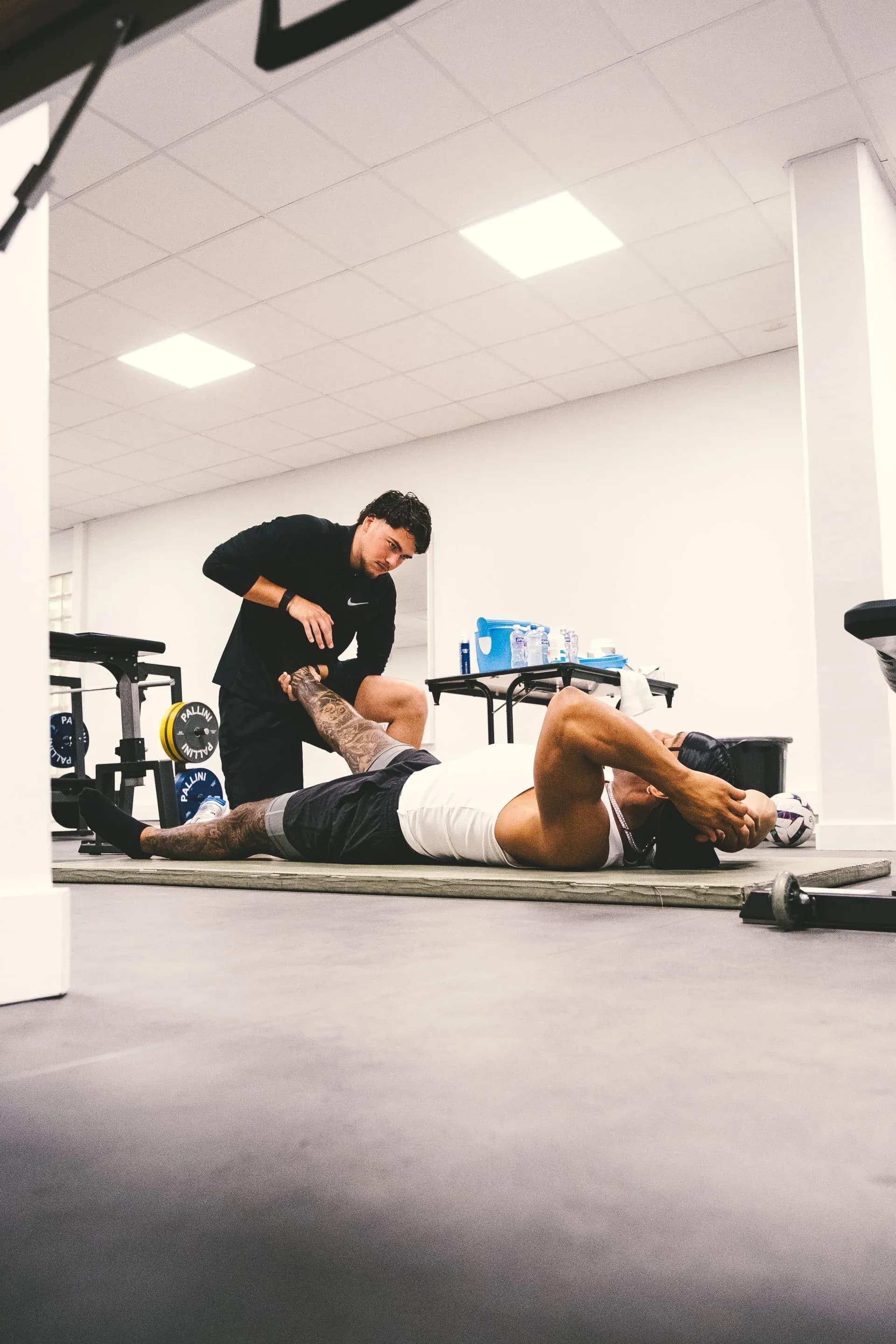 Nicolas Rausch giving a massage to Kyler Gordon during training